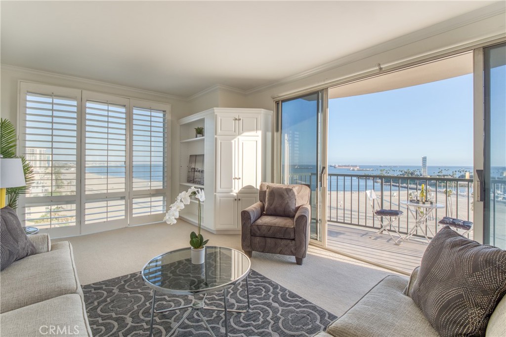 a living room with furniture and a floor to ceiling window