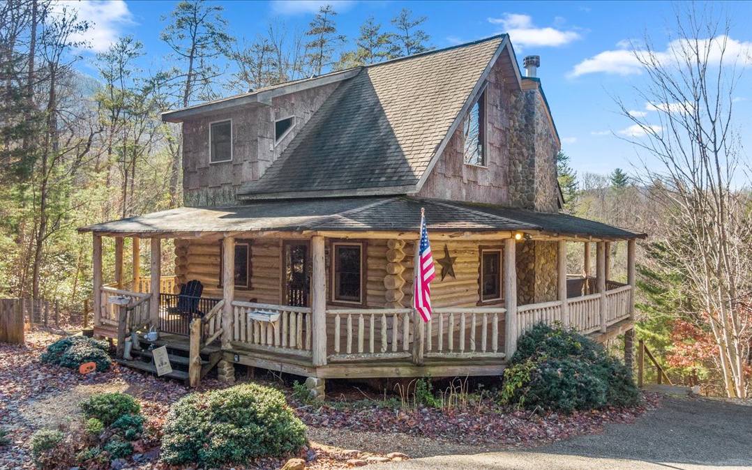 a view of a house with a yard and wooden deck