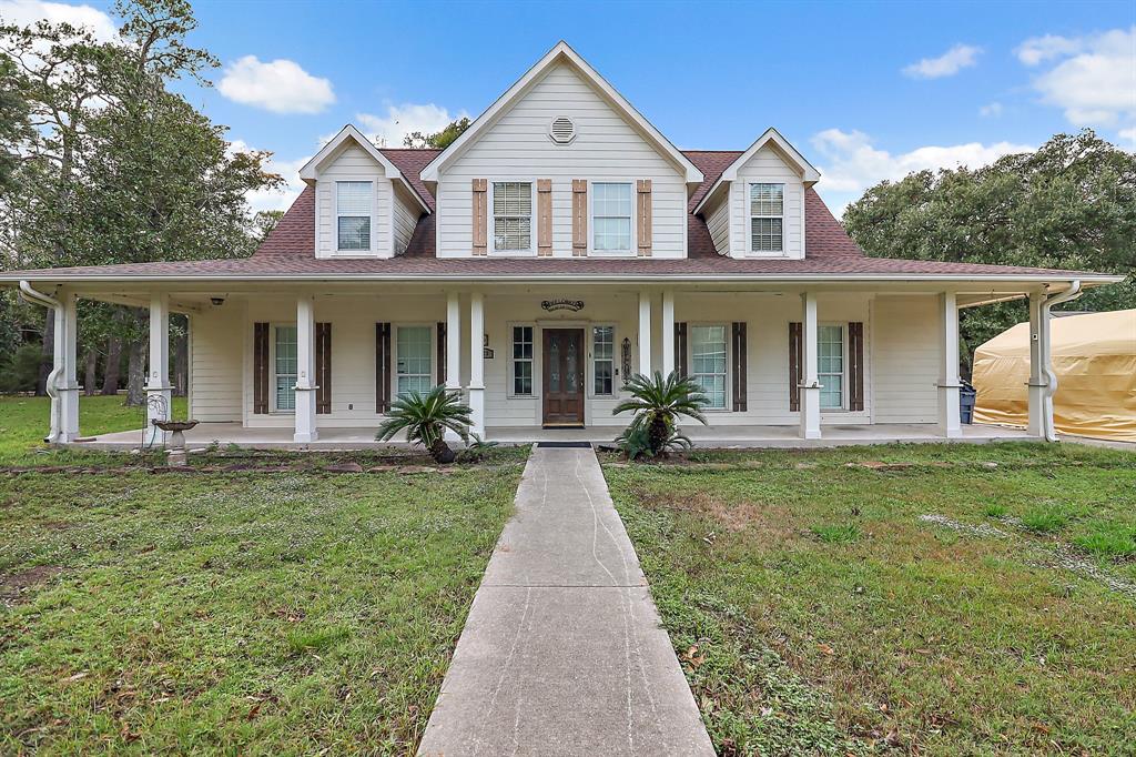 a front view of a house with yard and green space