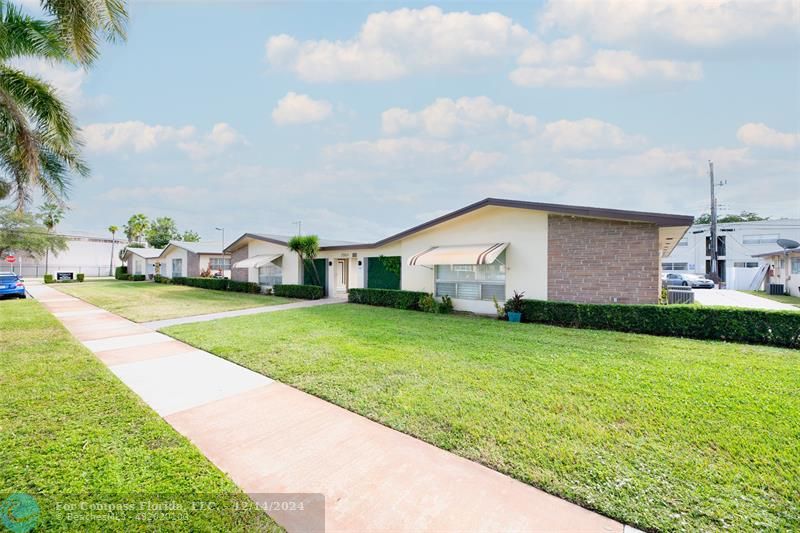 a house view with swimming pool and garden space