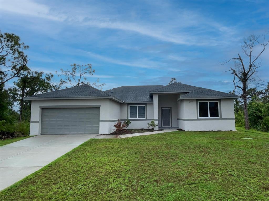 a front view of a house with a garden and yard