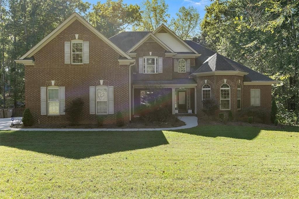 a front view of a house with a yard