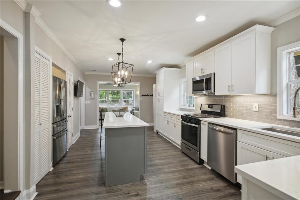 a large kitchen with cabinets and stainless steel appliances