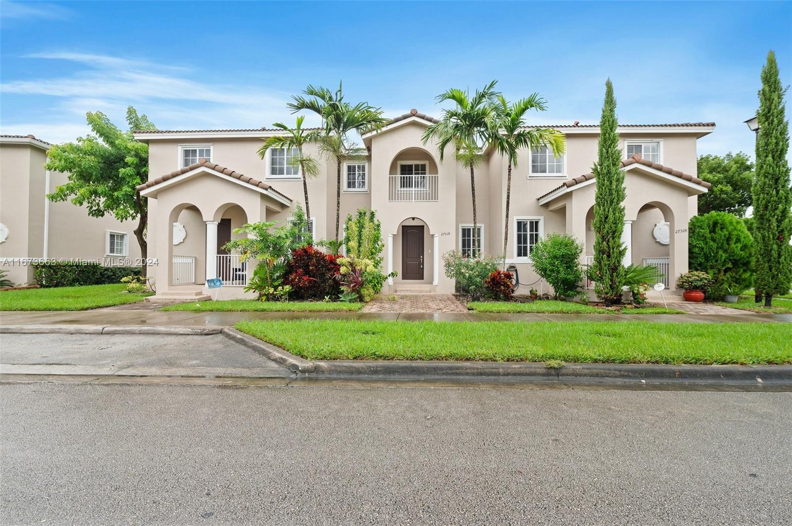 a front view of house with yard and green space