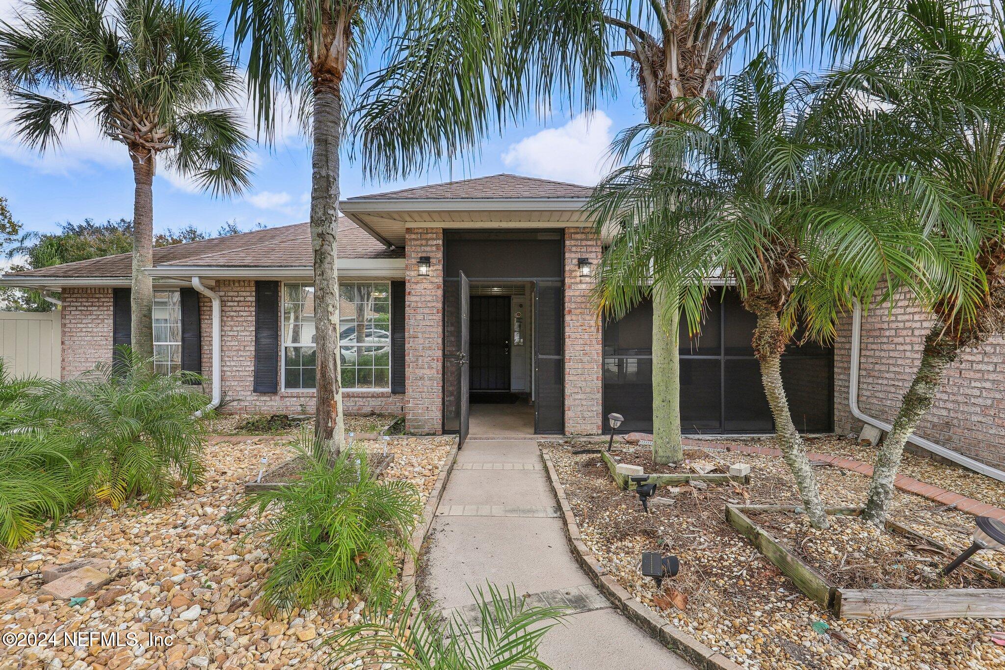 a front view of house with yard and green space