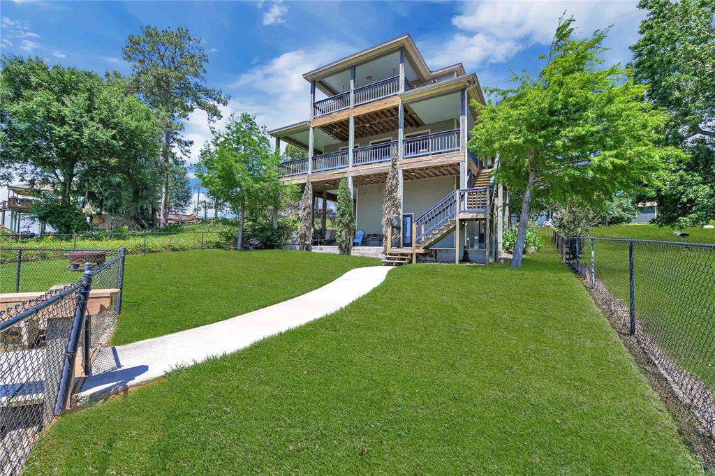 a view of a backyard with a garden and deck