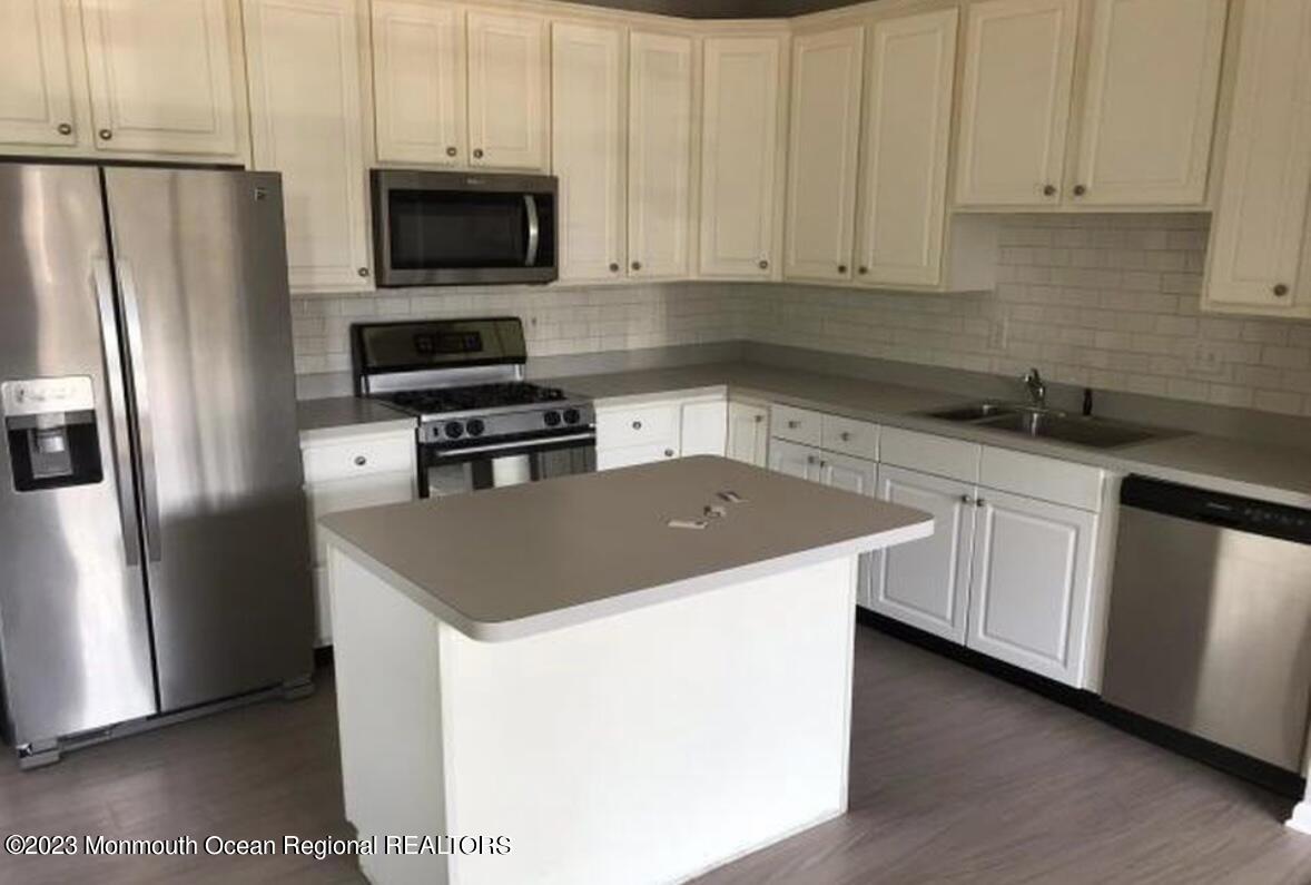 a kitchen with a sink stove and refrigerator