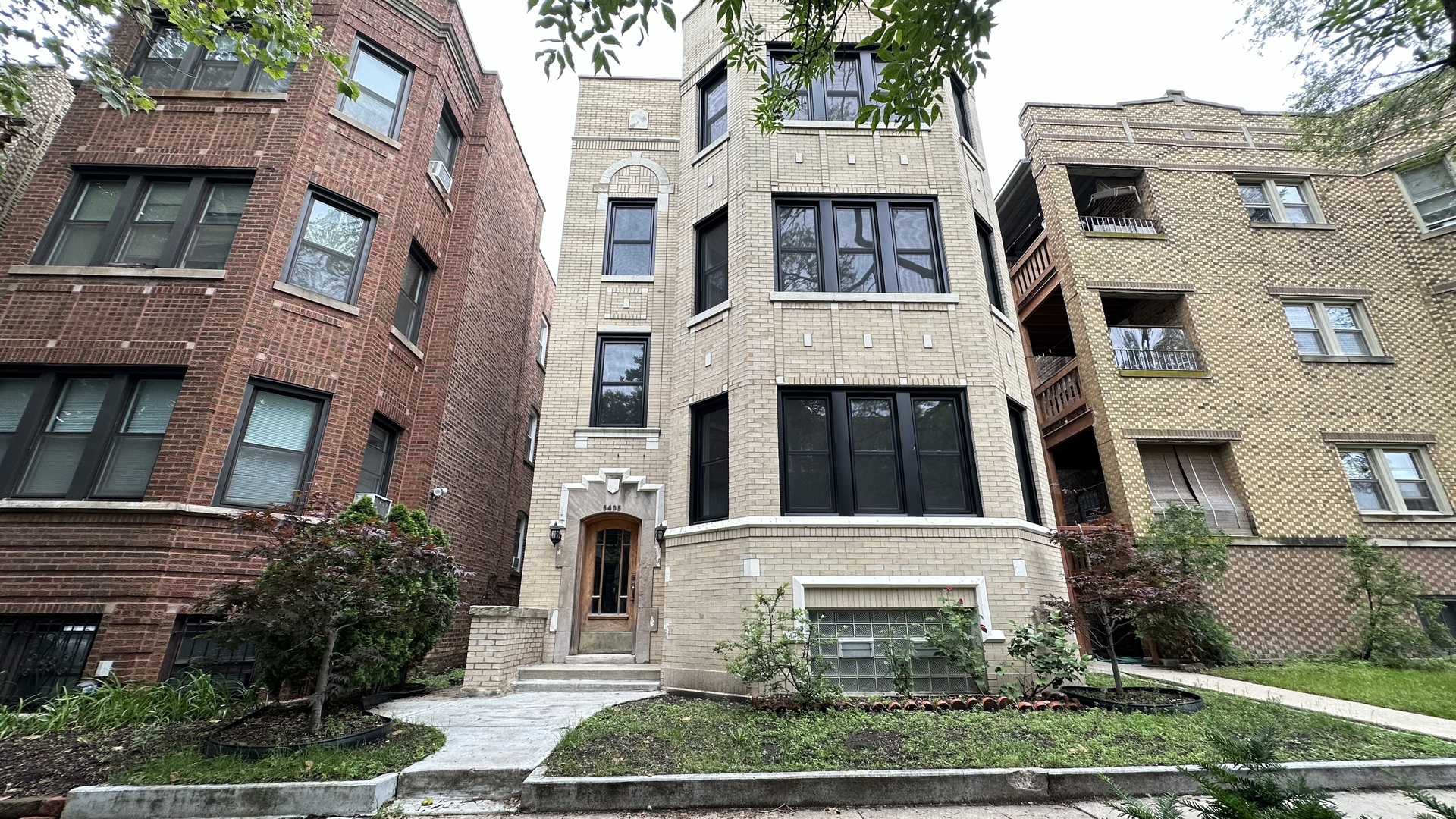 a front view of a building with a yard