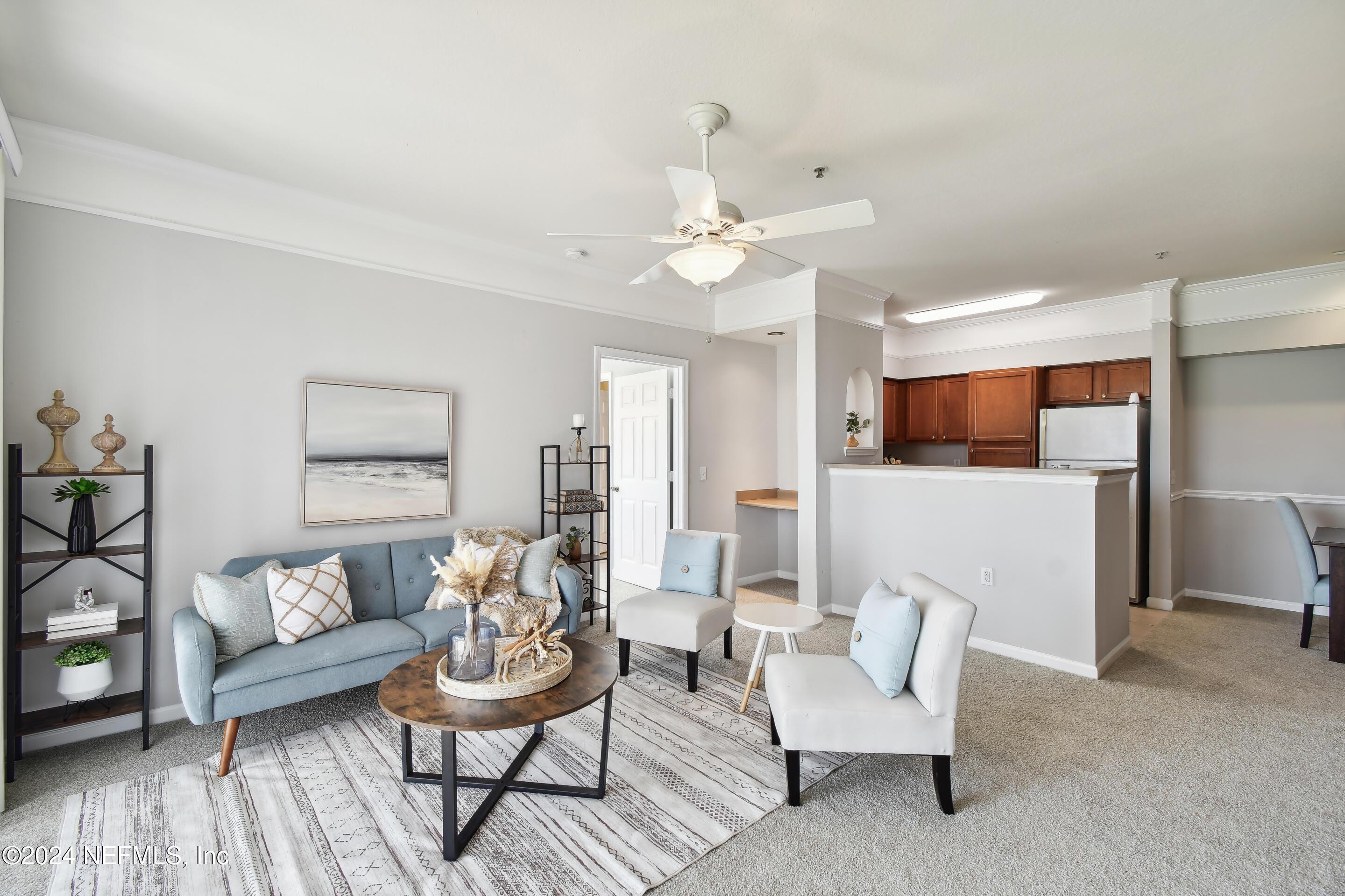 a living room with furniture and kitchen view