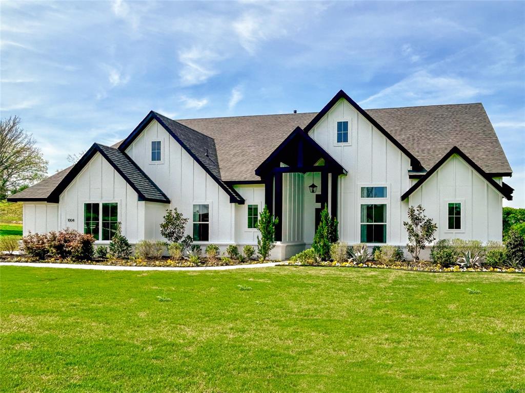 a front view of house with yard and green space