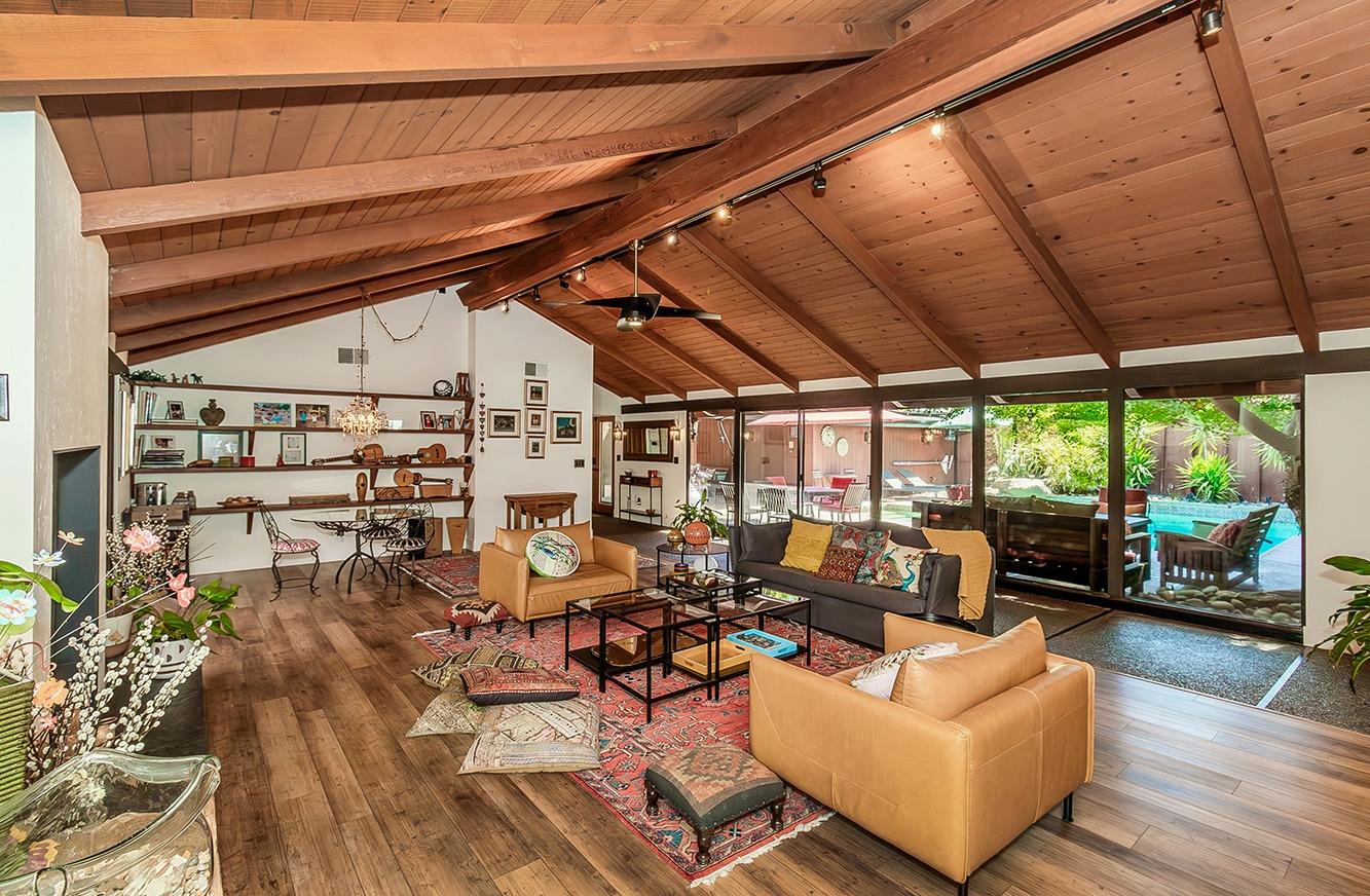 Living Room with glass wall and view of the courtyard. Love these vaulted ceilings.