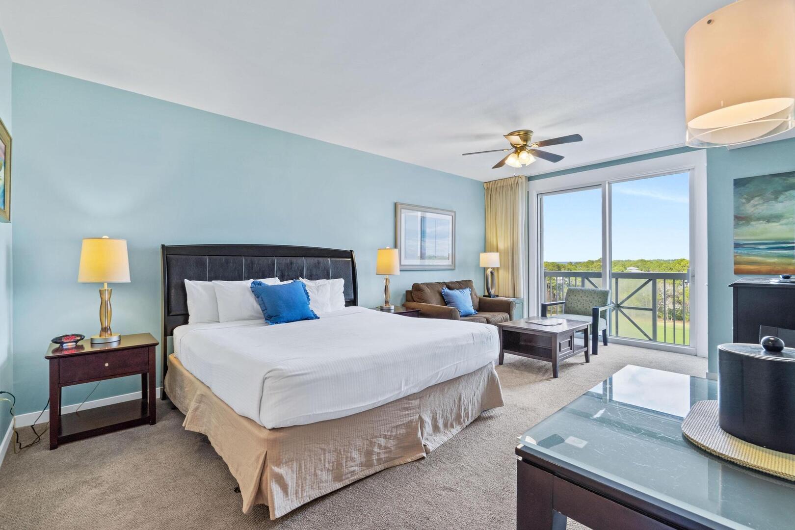 a bedroom with a large bed and a chandelier