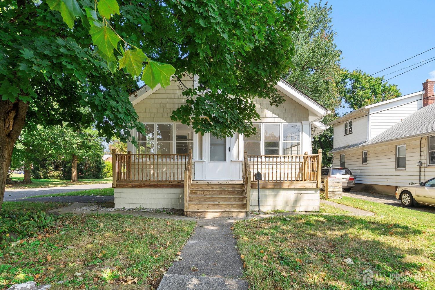 a view of a house with backyard and a tree