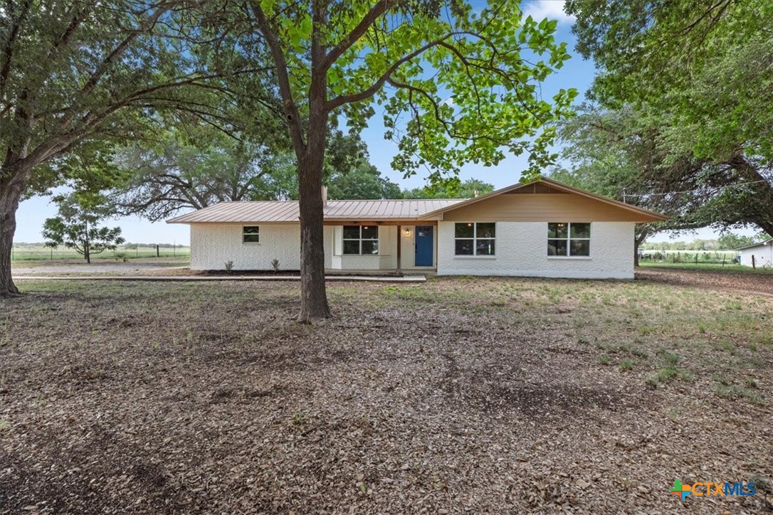 a house with trees in the background