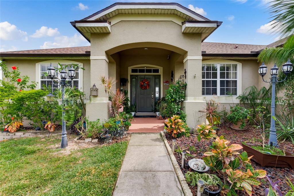 a front view of a house with garden