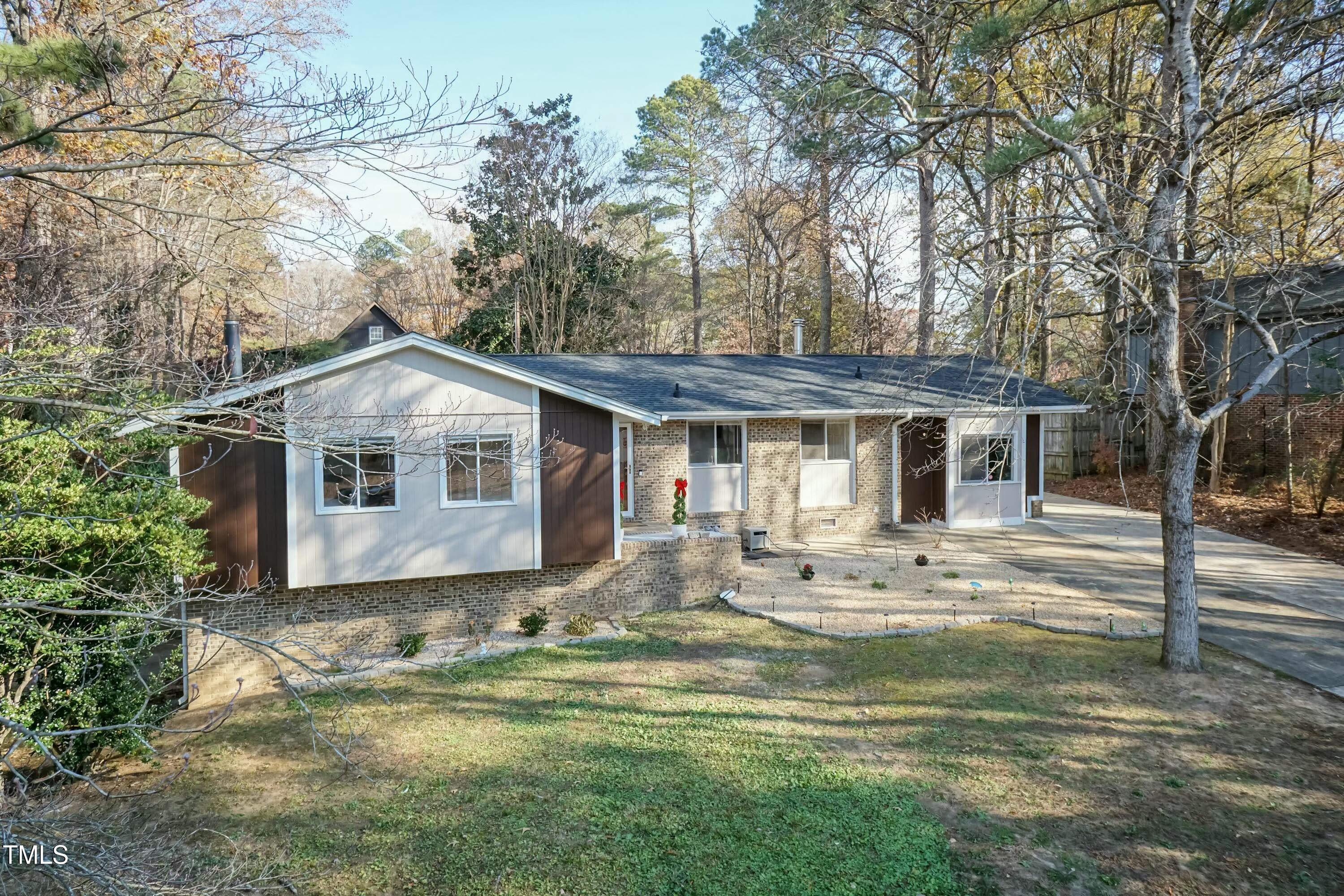 a front view of house with yard outdoor seating and barbeque oven