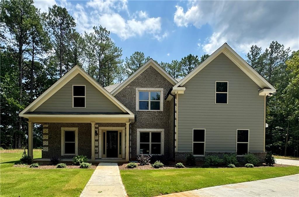 a front view of house with yard and green space