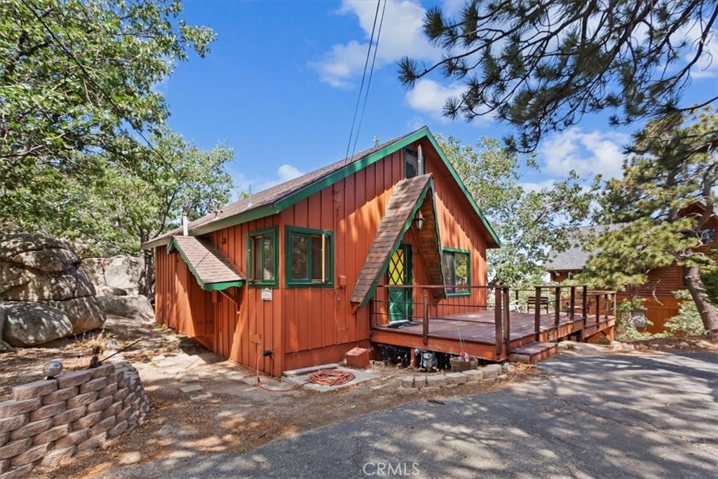 a view of a house with a yard and wooden fence