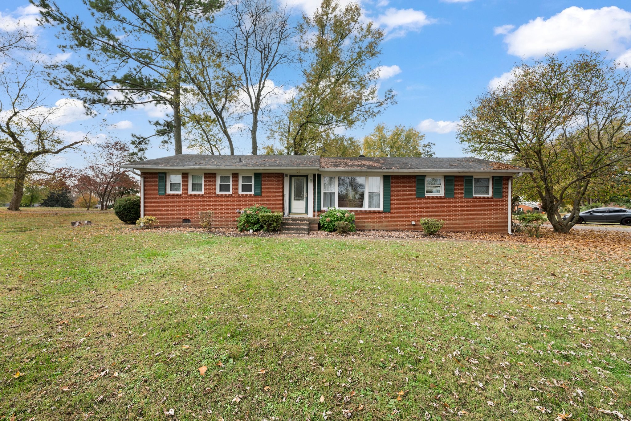 a front view of house with yard and green space