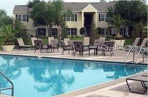 a view of a swimming pool with a table and chairs