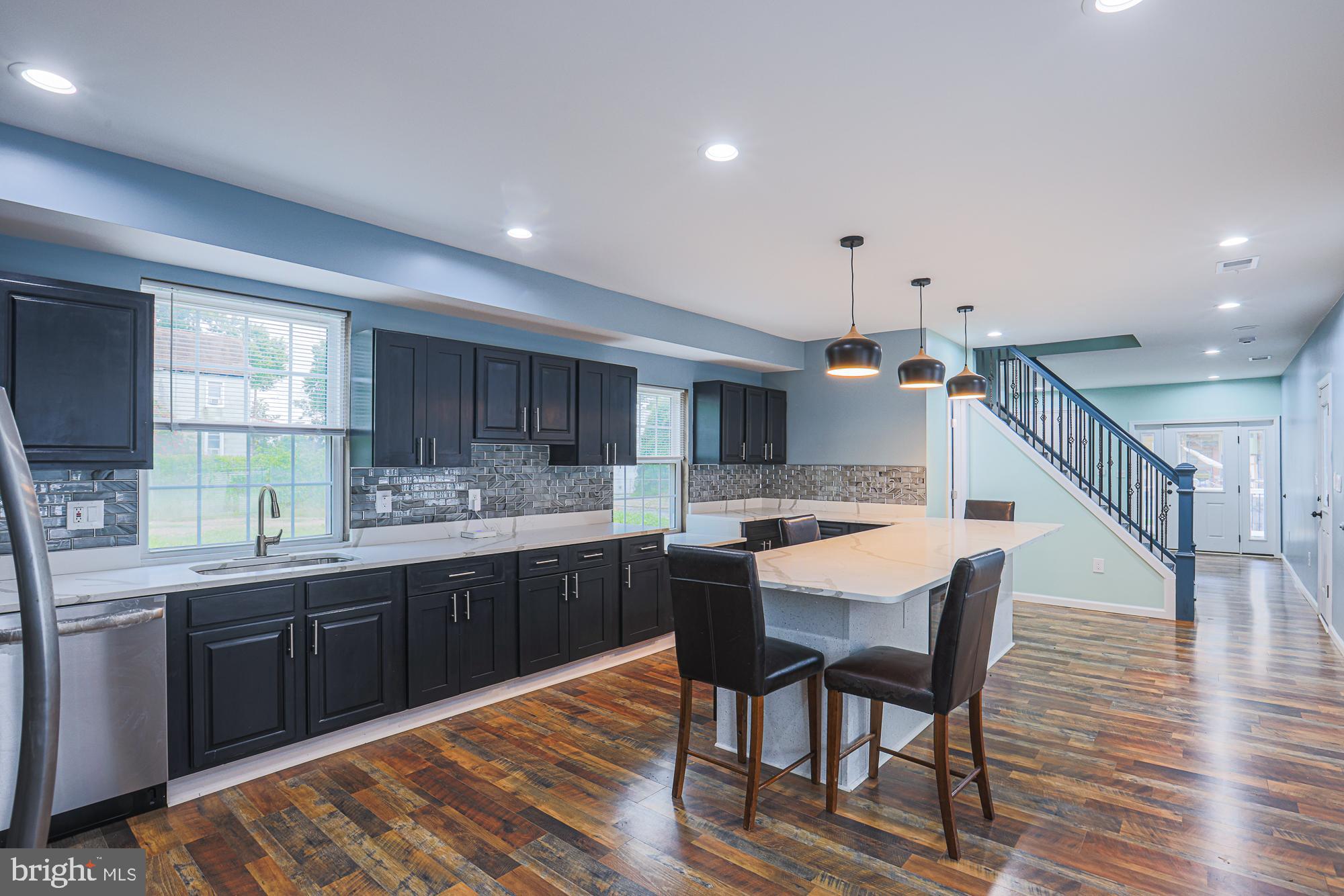 a large kitchen with a table and chairs in it