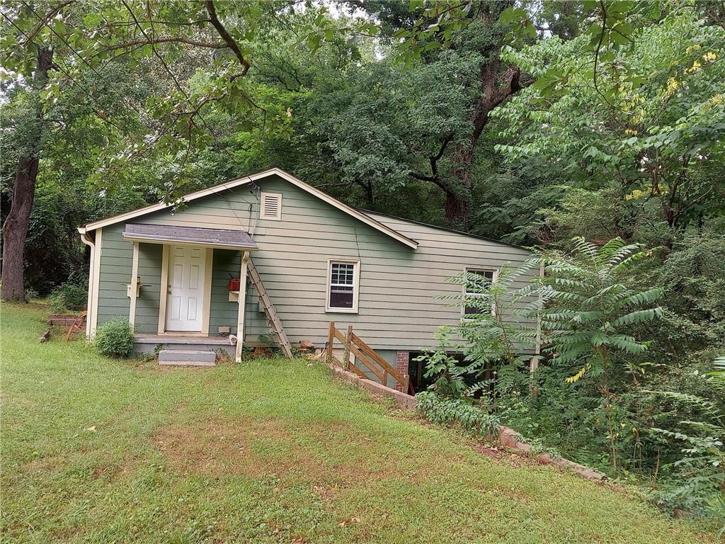 a front view of house with yard and green space