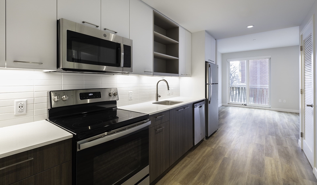 a kitchen with a sink stove and microwave