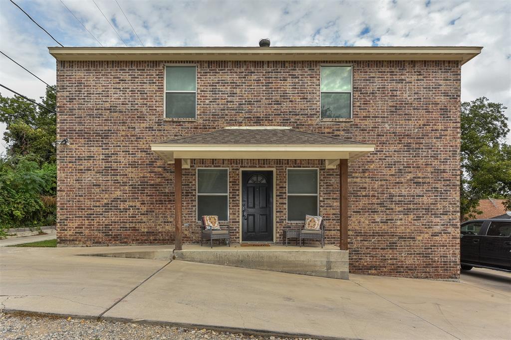 front view of a brick house with a outdoor space