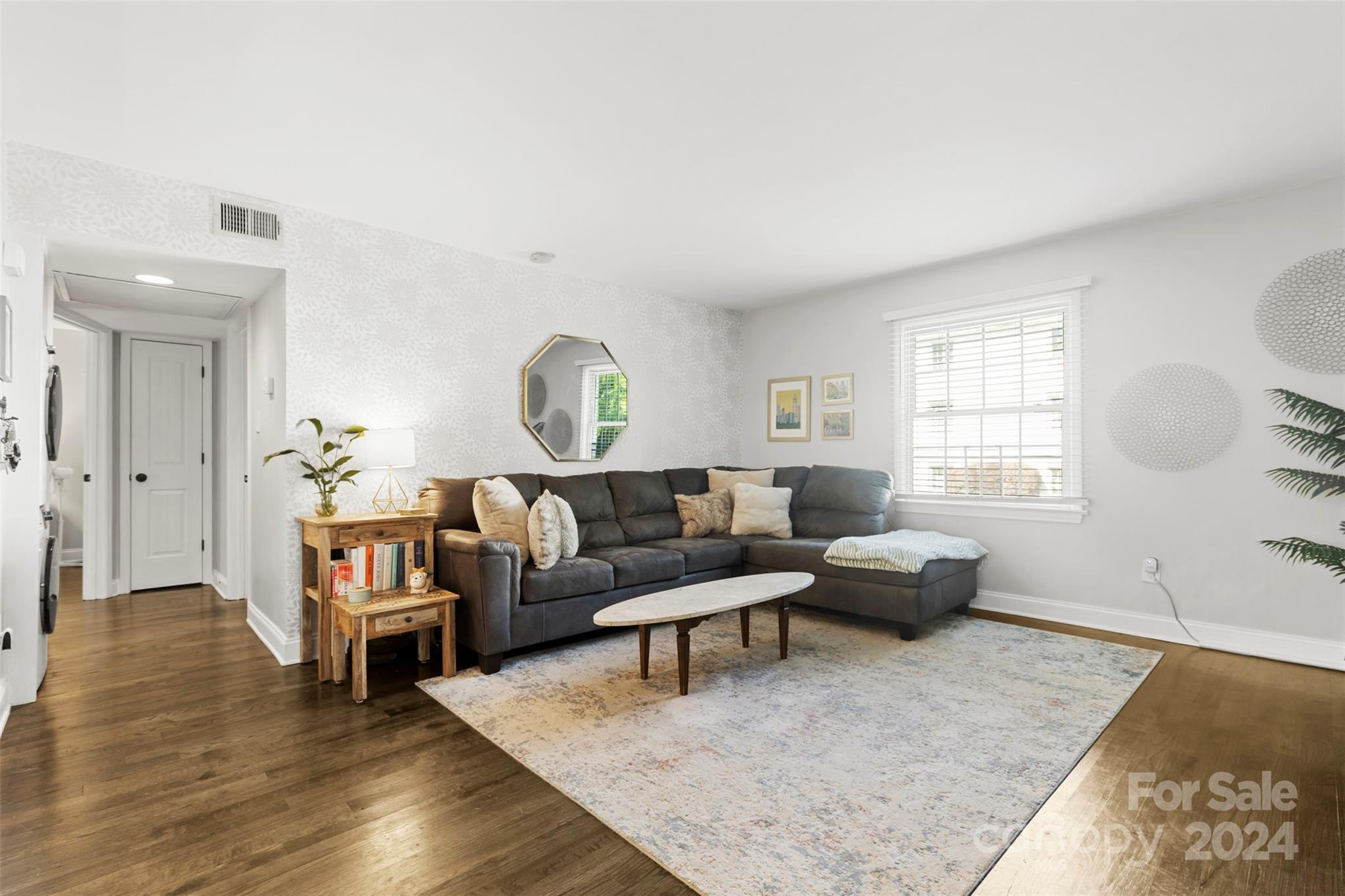 a living room with fireplace furniture and a window