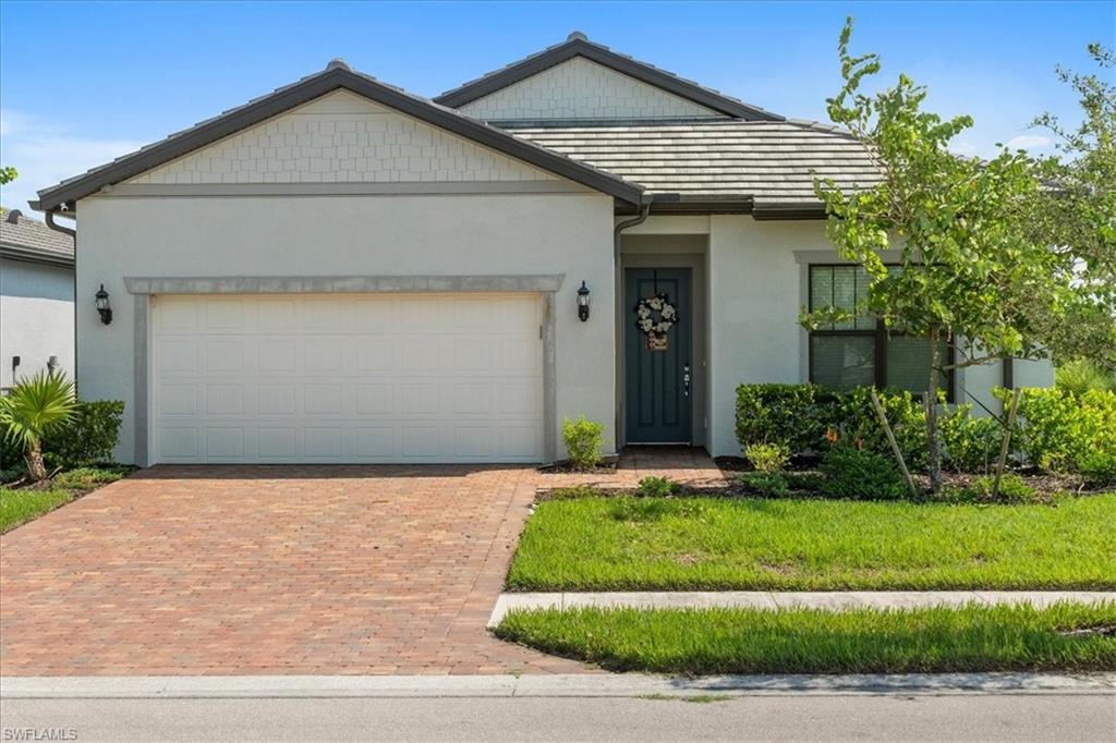 a front view of a house with a yard and garage