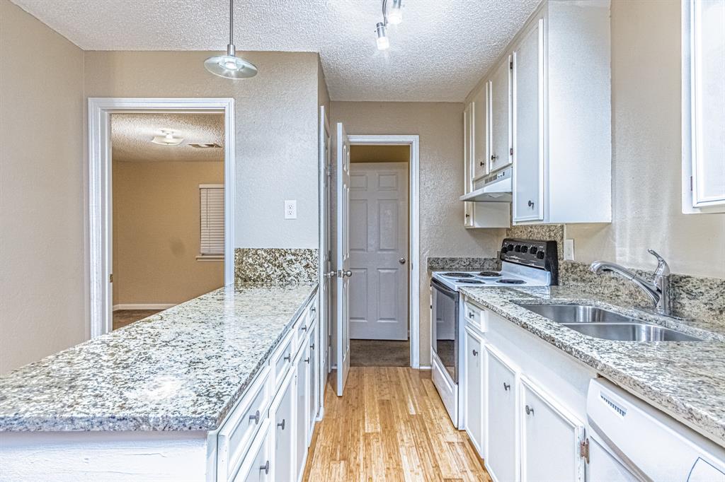 a kitchen with a stove sink and refrigerator