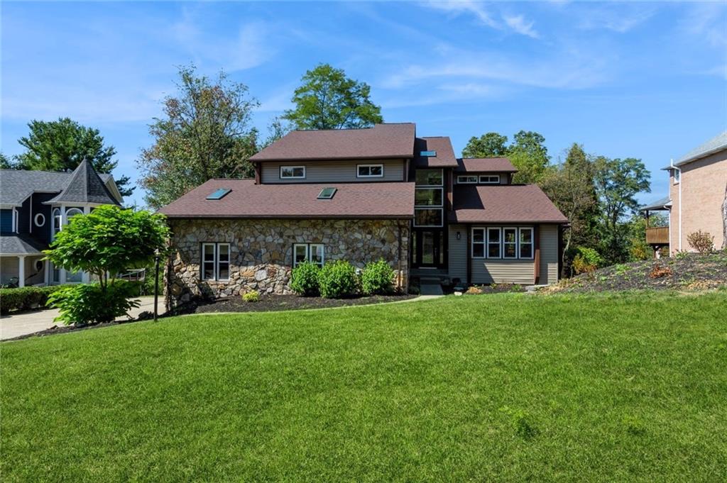 a front view of a house with a garden