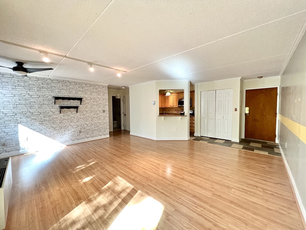 a view of empty room with wooden floor