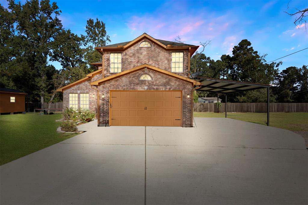 a front view of a house with a yard and garage