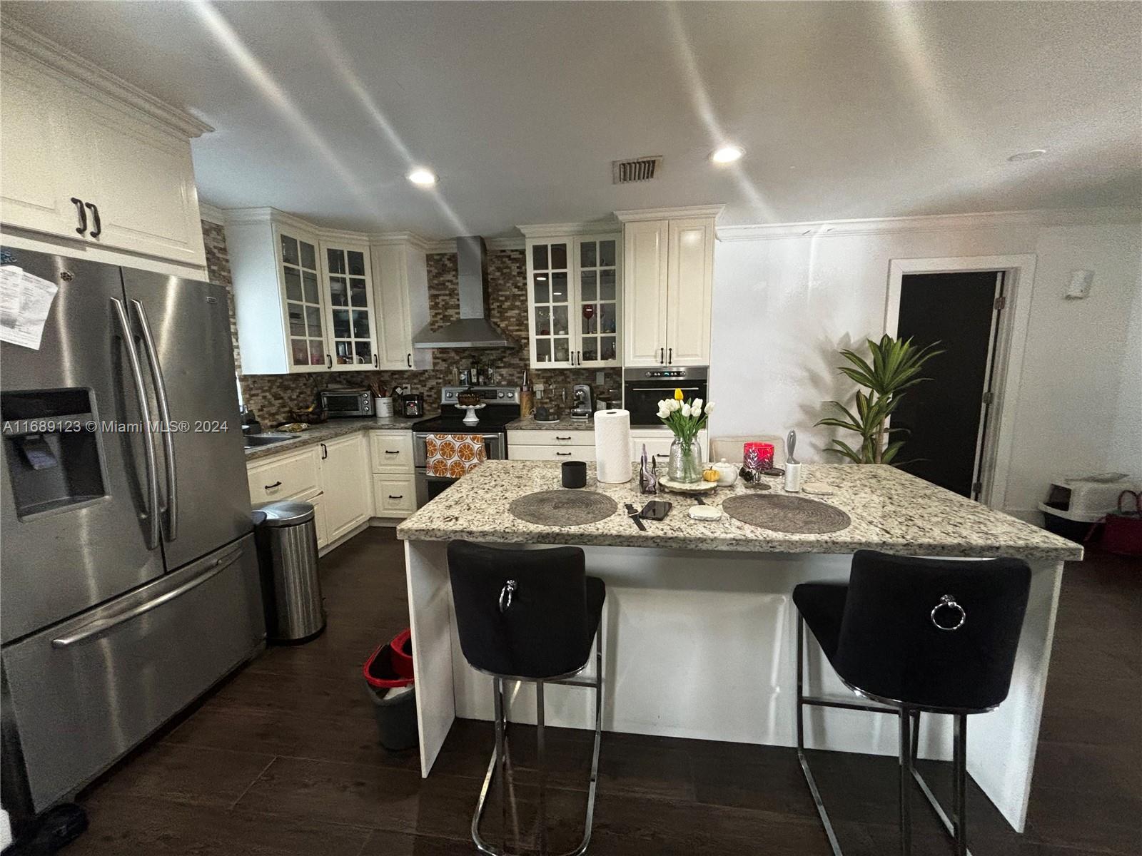 a kitchen with a counter space appliances and cabinets