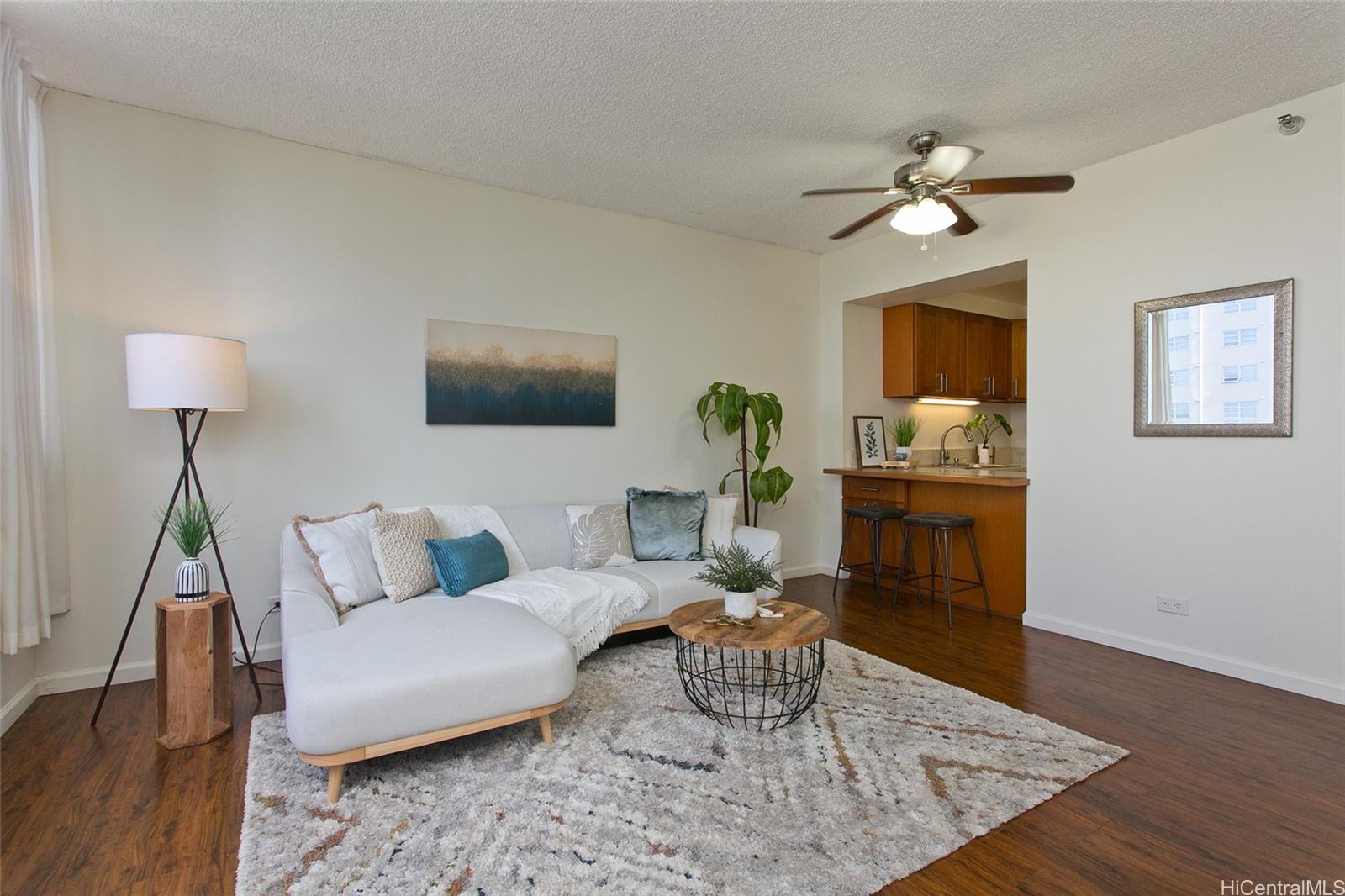 a living room with furniture and wooden floor