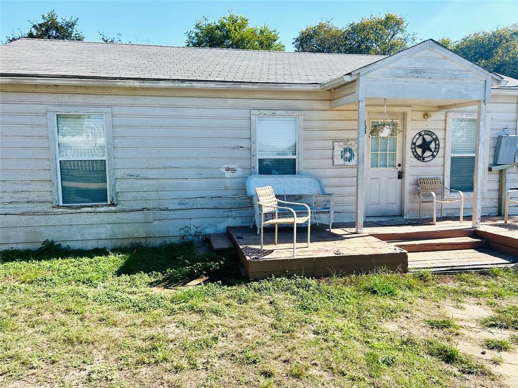 a view of a house with a backyard and a patio