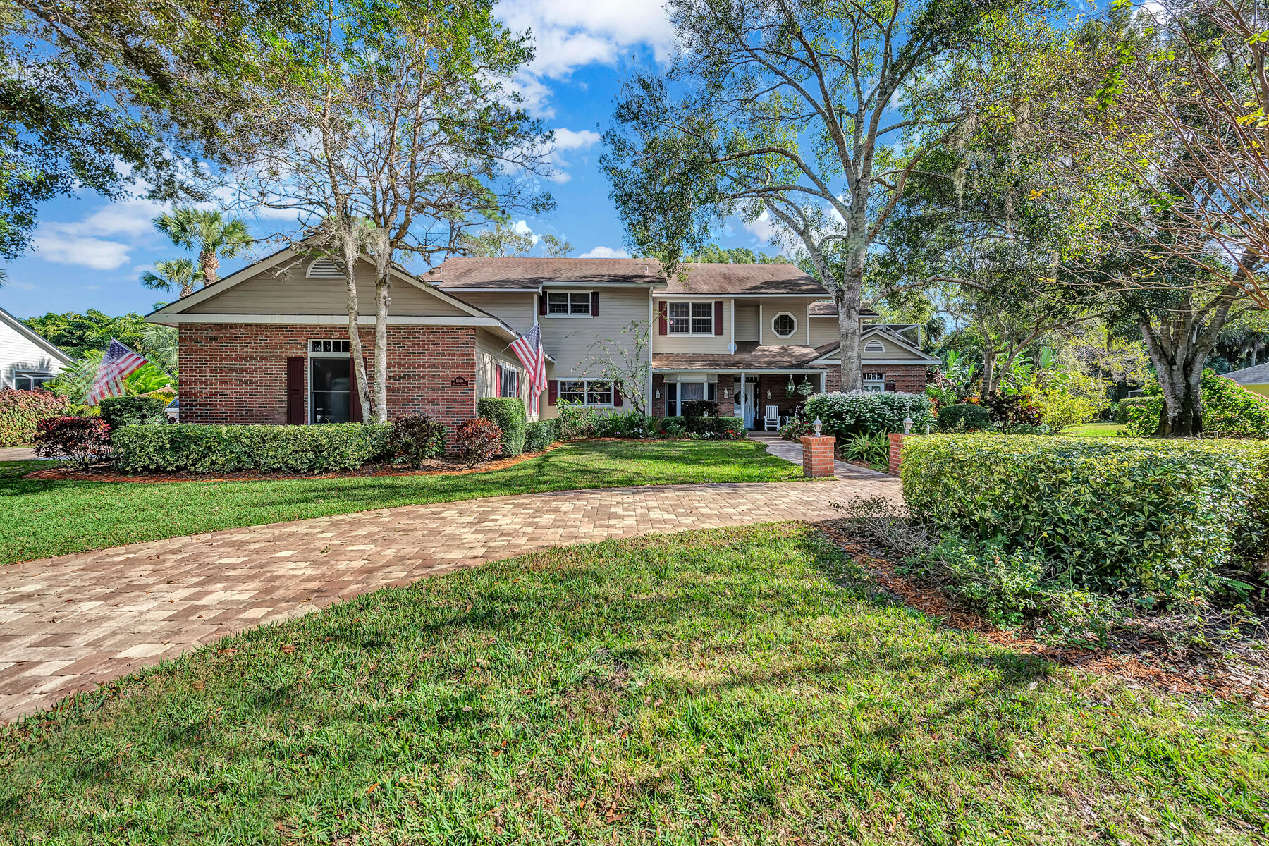 a front view of a house with a yard and trees