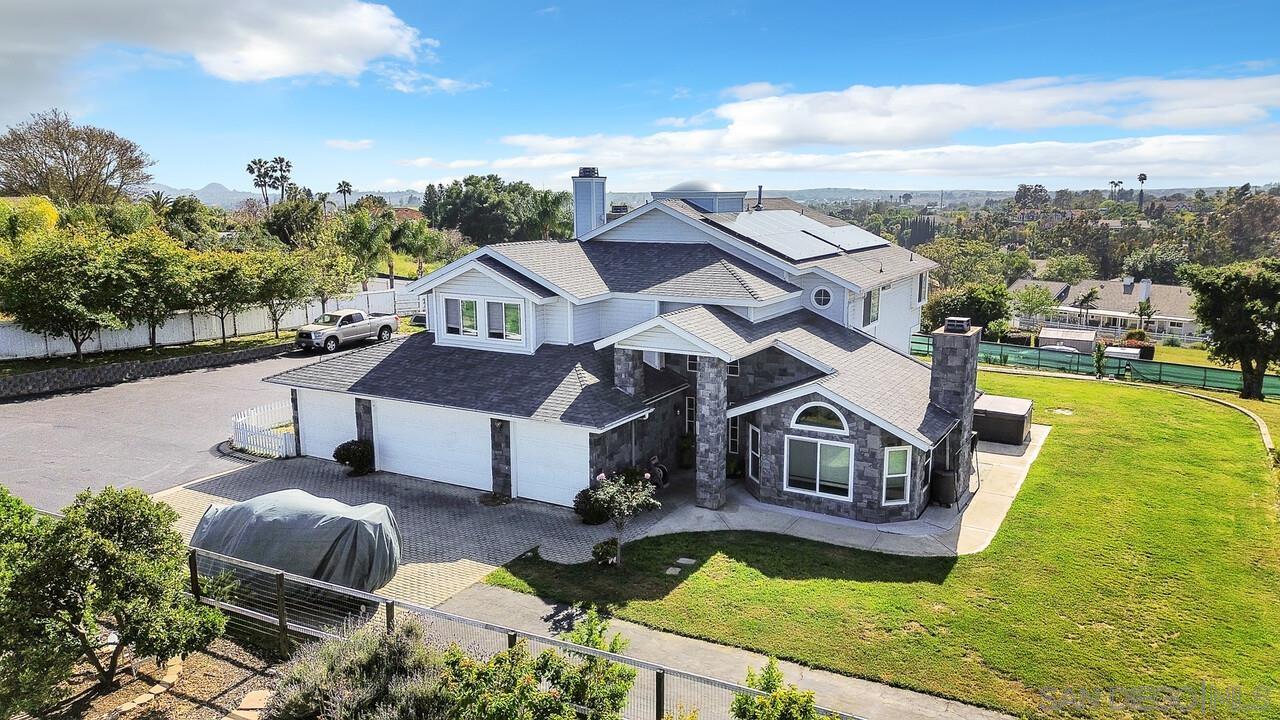 a aerial view of a house with swimming pool and a yard