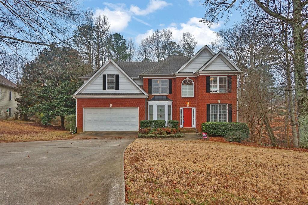 a front view of a house with a yard