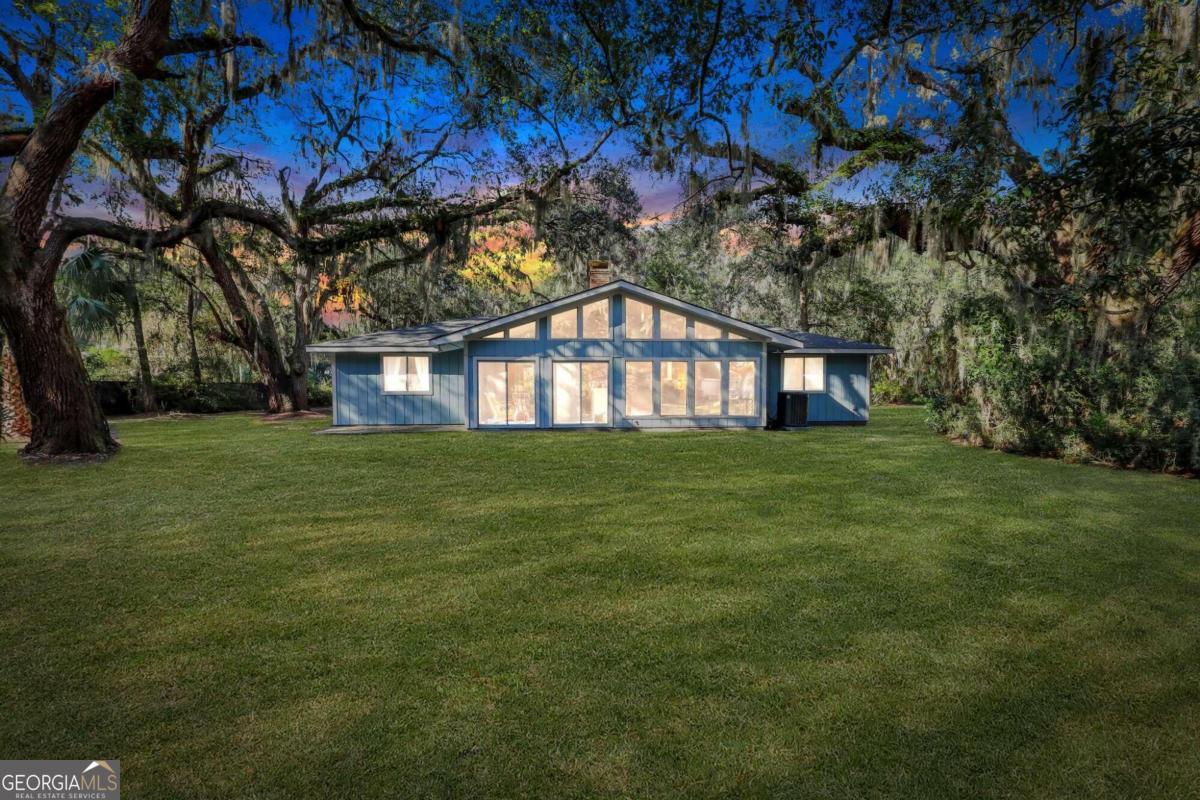 a front view of a house with a big yard