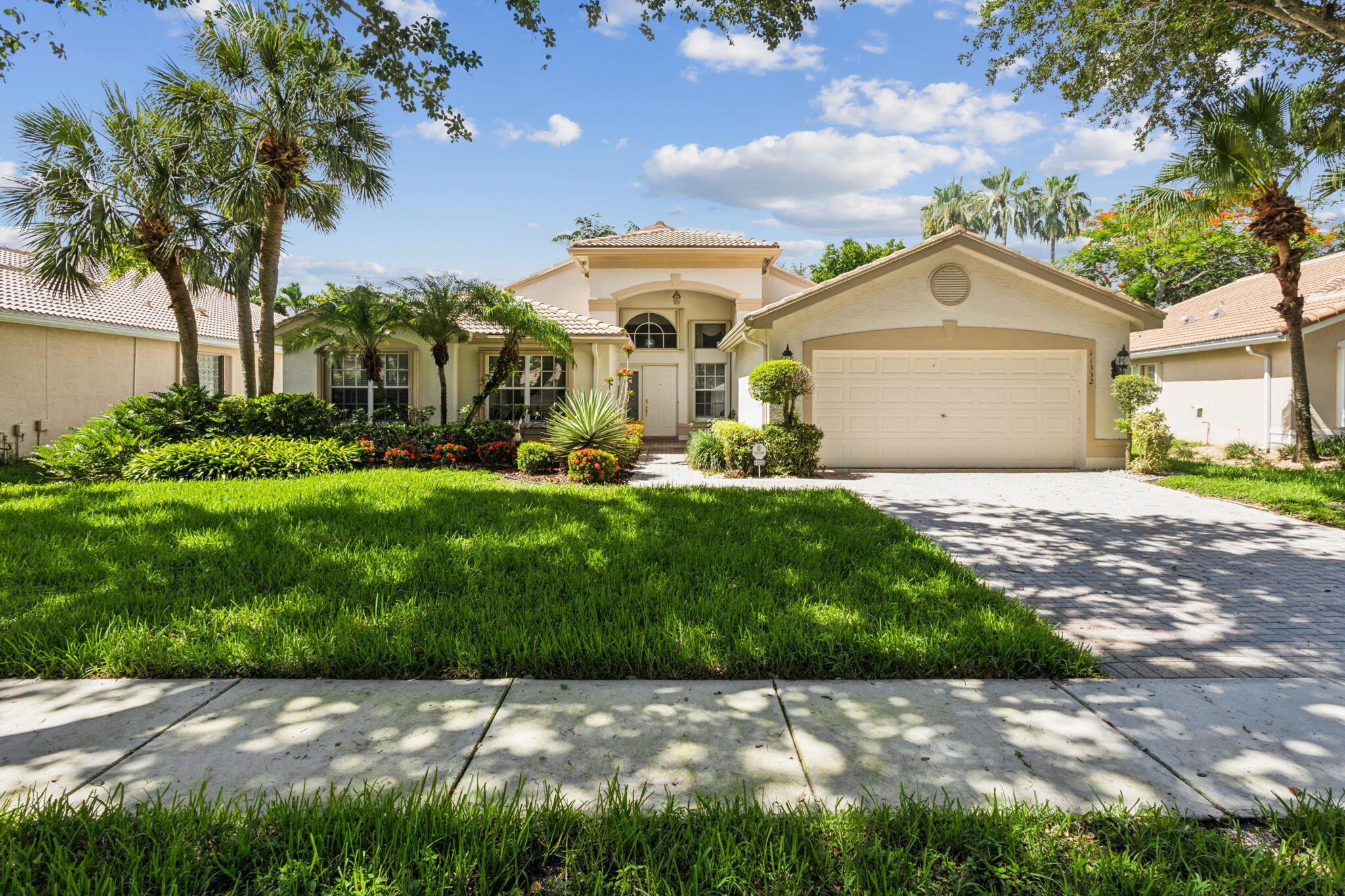 a front view of a house with a garden and yard