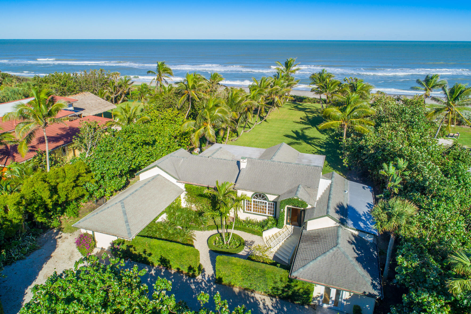 an aerial view of a house with a yard