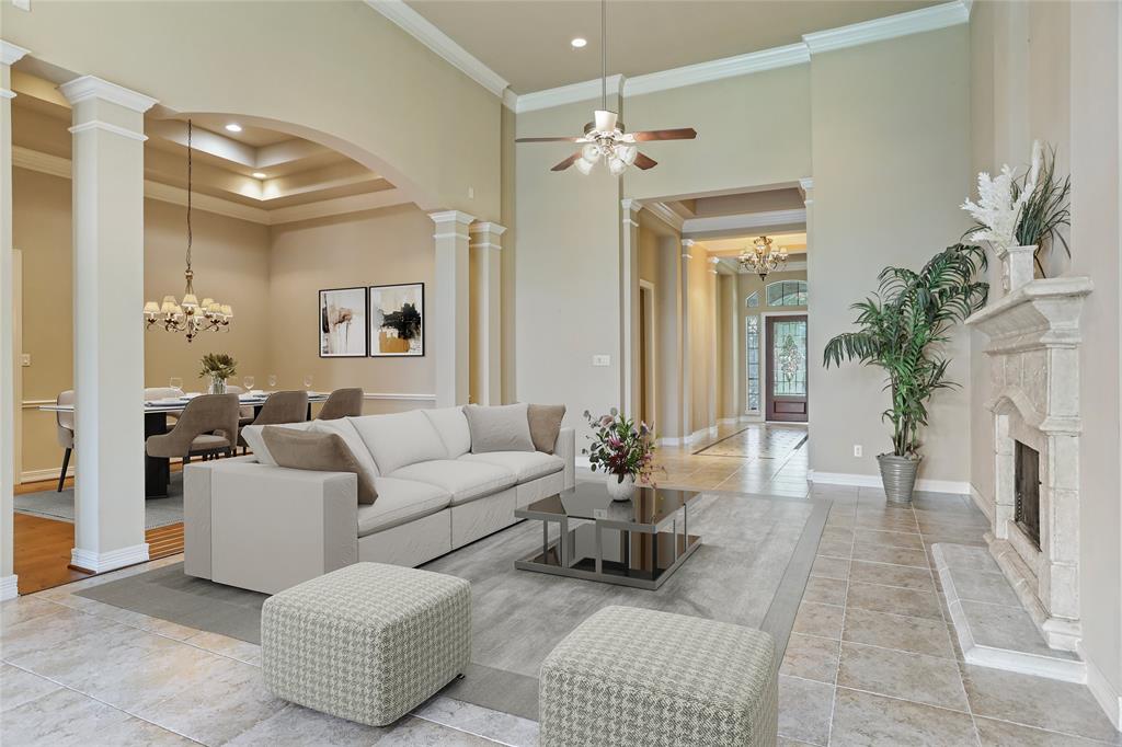 a living room with furniture and a chandelier