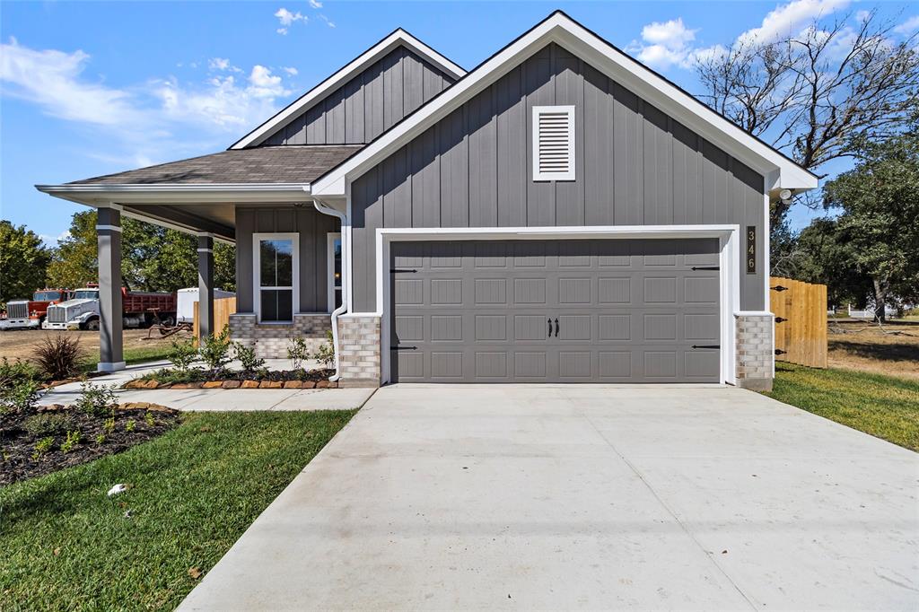 a front view of house with yard and outdoor seating