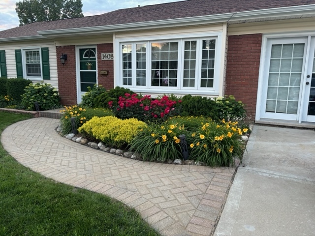 a front view of a house with a yard and fountain