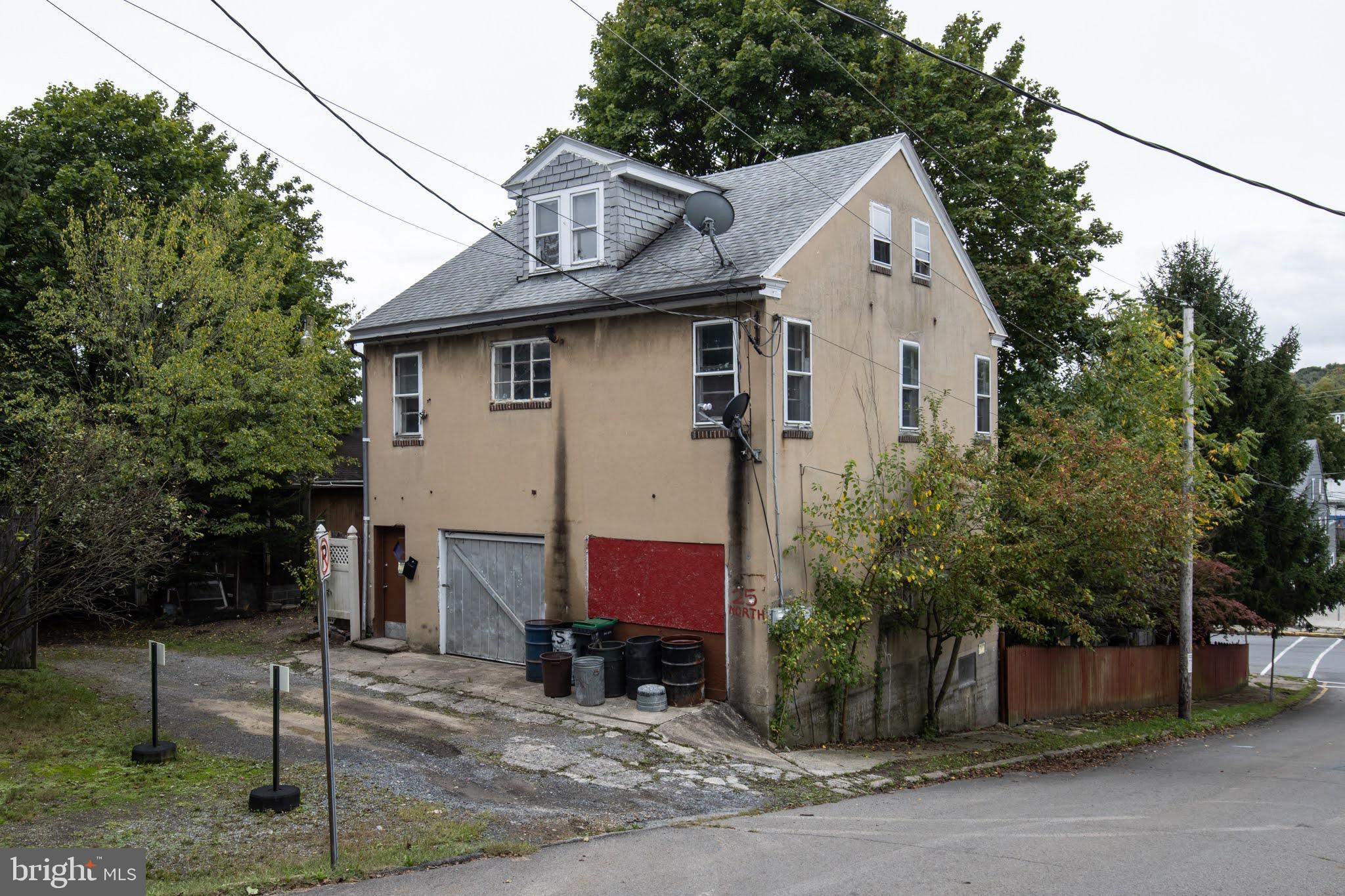 a view of a house with a yard and tree s