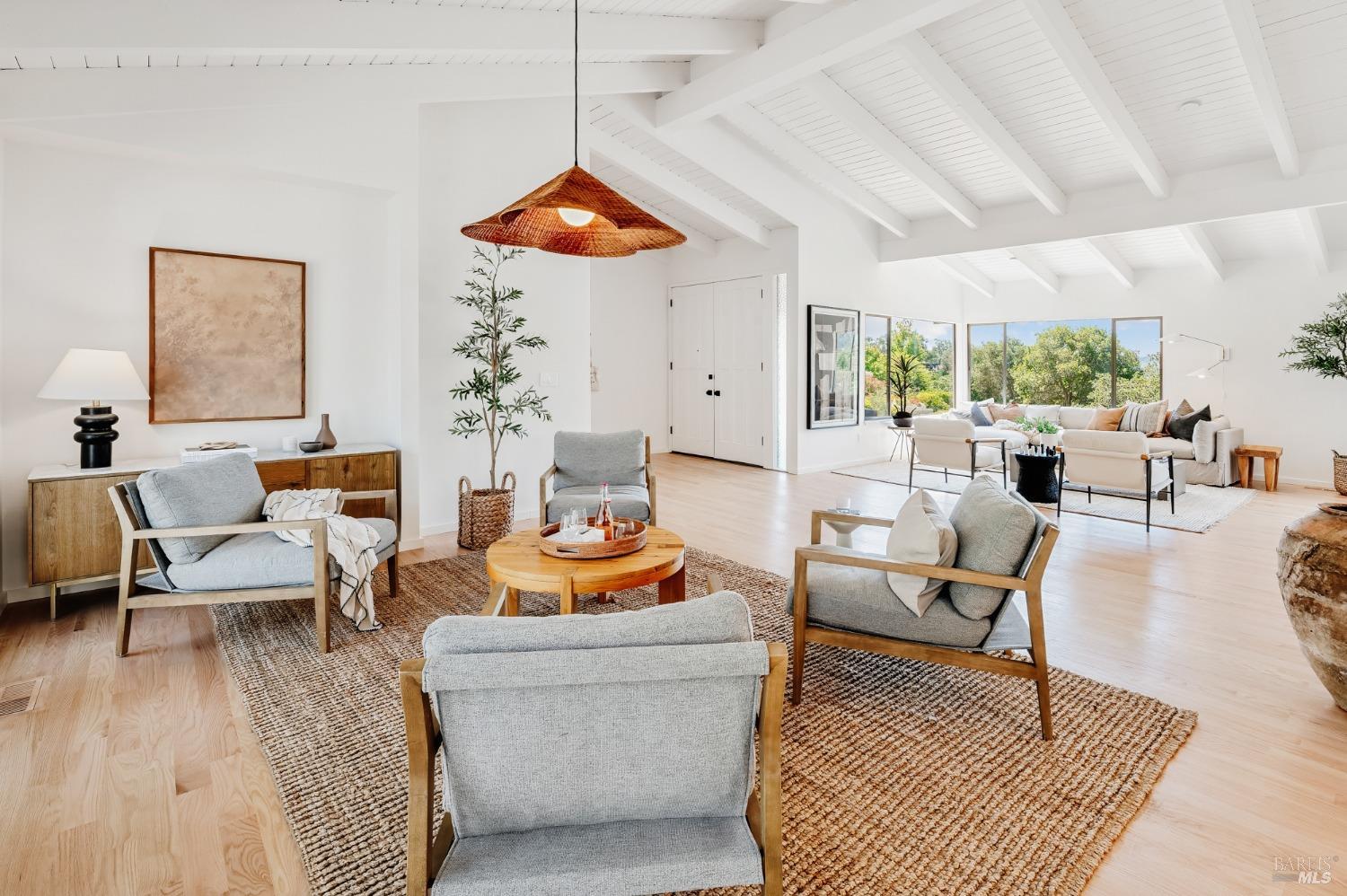 a living room with furniture a rug and a large window