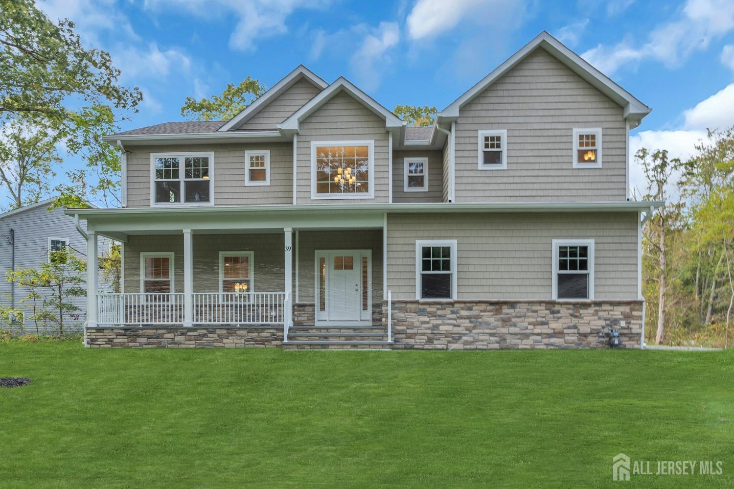 a front view of a house with a garden