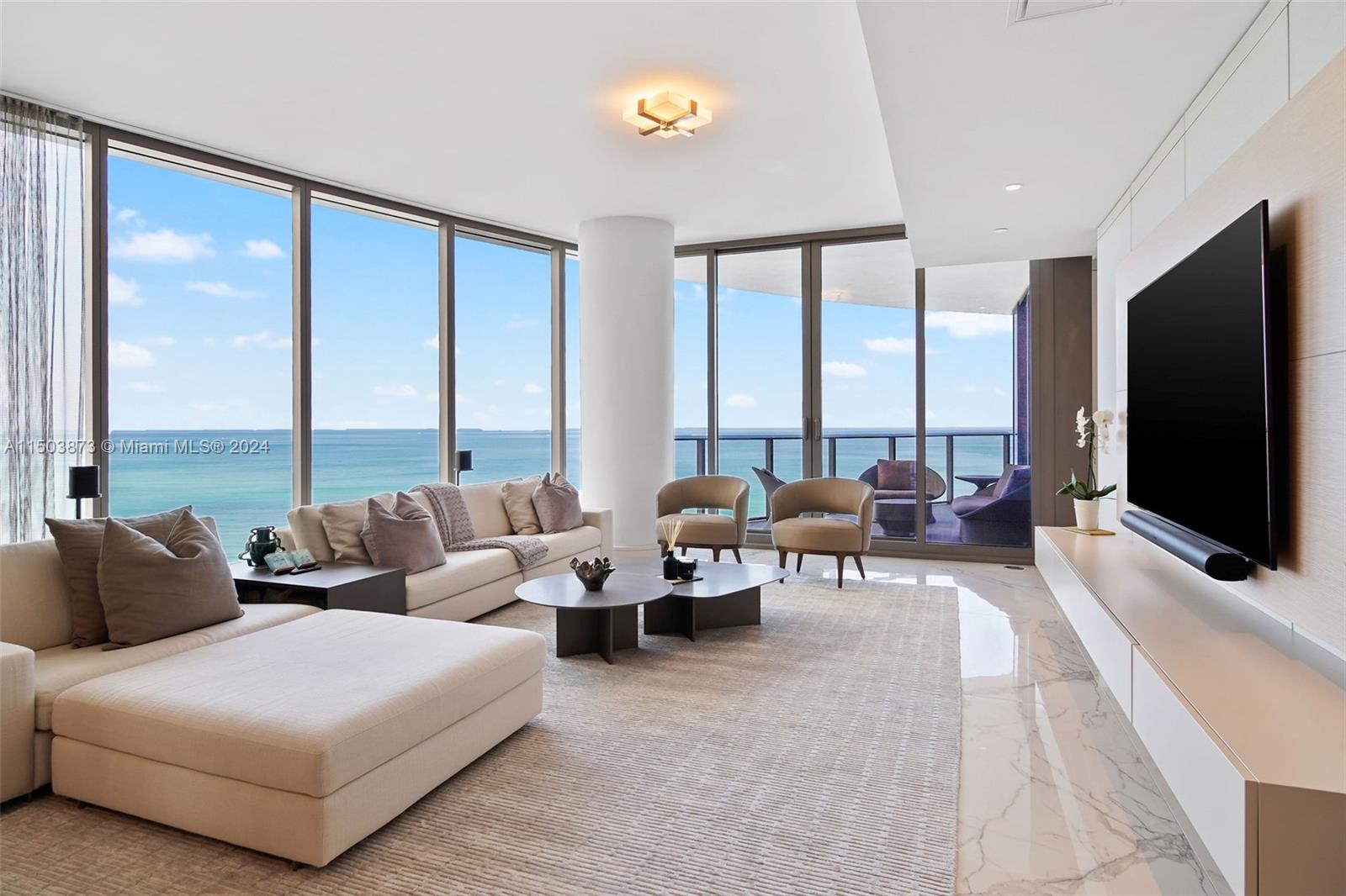 a living room with furniture and large windows